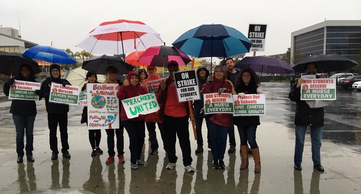 Author Larry Strauss, center in red hat, joins colleagues on the streets earlier this week.