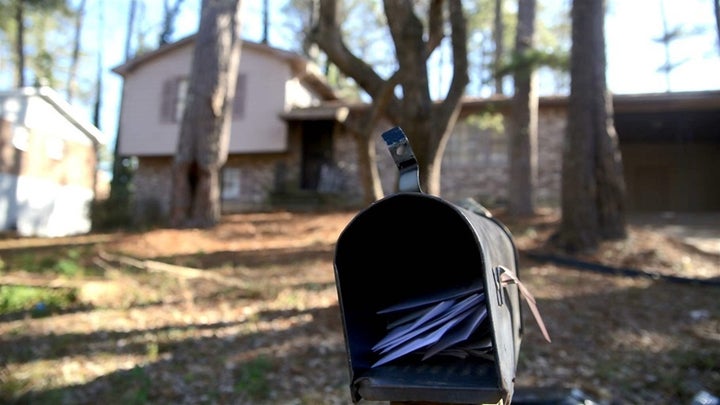 Letters pile up in the mailbox of the College Park, Georgia, split-level home from which the Hicks family was recently evicte
