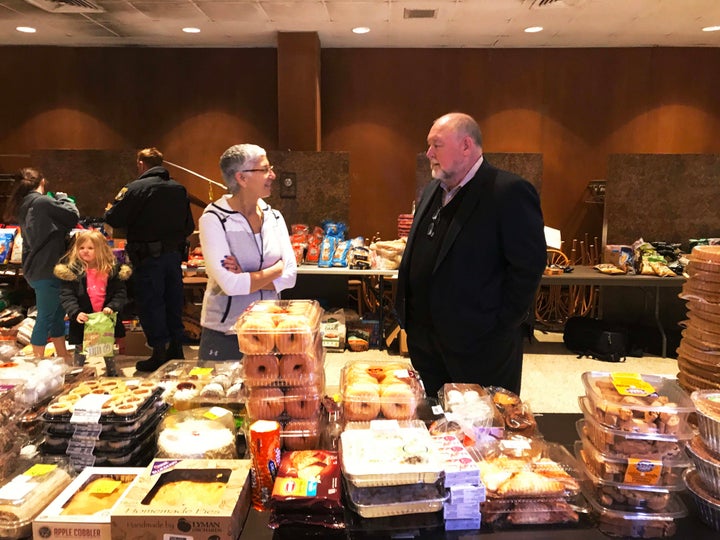 Thad Allen, retired Coast Guard commandant, speaks with a volunteer at the Coast Guard Academy in New London, Connecticut, on Thursday.