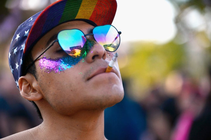 A participant smokes a cigarette at the LA Pride Music Festival and Parade 2017 on June 10, 2017 in West Hollywood, California. (Photo by Chelsea Guglielmino/Getty Images)