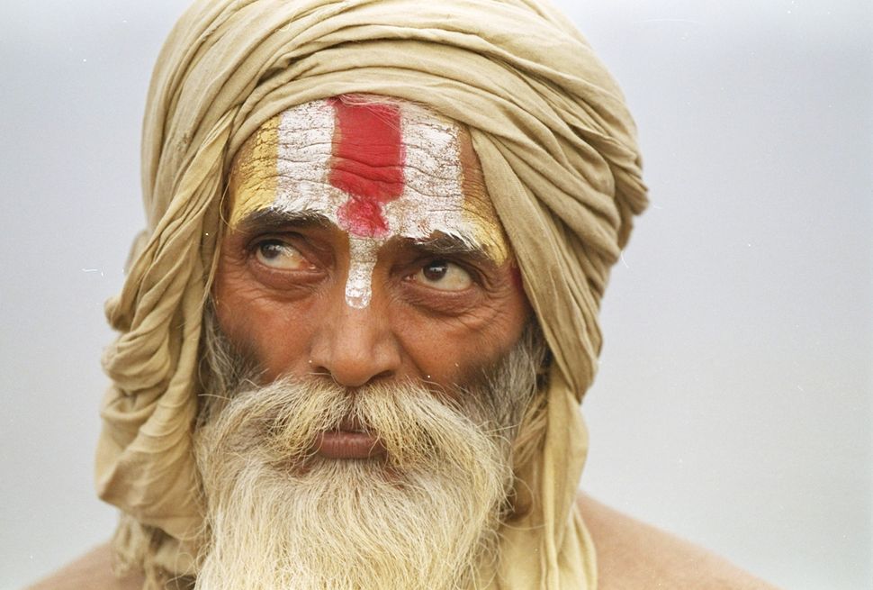A sadhu listens to a speech marking the first anniversary of the destruction of the Babri Mosque in Ayodhya, December 6, 1992. 