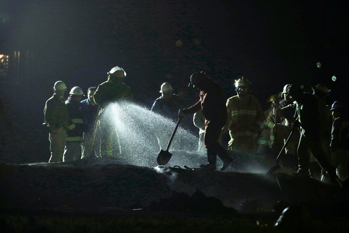 Staff of Pemex, Petroleos Mexicanos, works the area of a oil pipeline explosion in Tlahuelilpan, Hidalgo state.