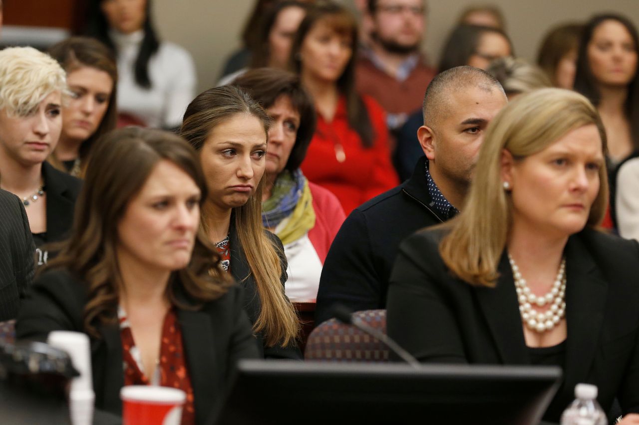 Kyle Stephens(CenterL) and other people react as former Michigan State University and USA Gymnastics doctor Larry Nassar listens to impact statements during the sentencing phase in Ingham County Circuit Court on January 24, 2018 in Lansing, Michigan.More than 100 women and girls accuse Nassar of a pattern of serial abuse dating back two decades, including the Olympic gold-medal winners Simone Biles, Aly Raisman, Gabby Douglas and McKayla Maroney -- who have lashed out at top sporting officials for failing to stop him. / AFP PHOTO / JEFF KOWALSKY (Photo credit should read JEFF KOWALSKY/AFP/Getty Images)