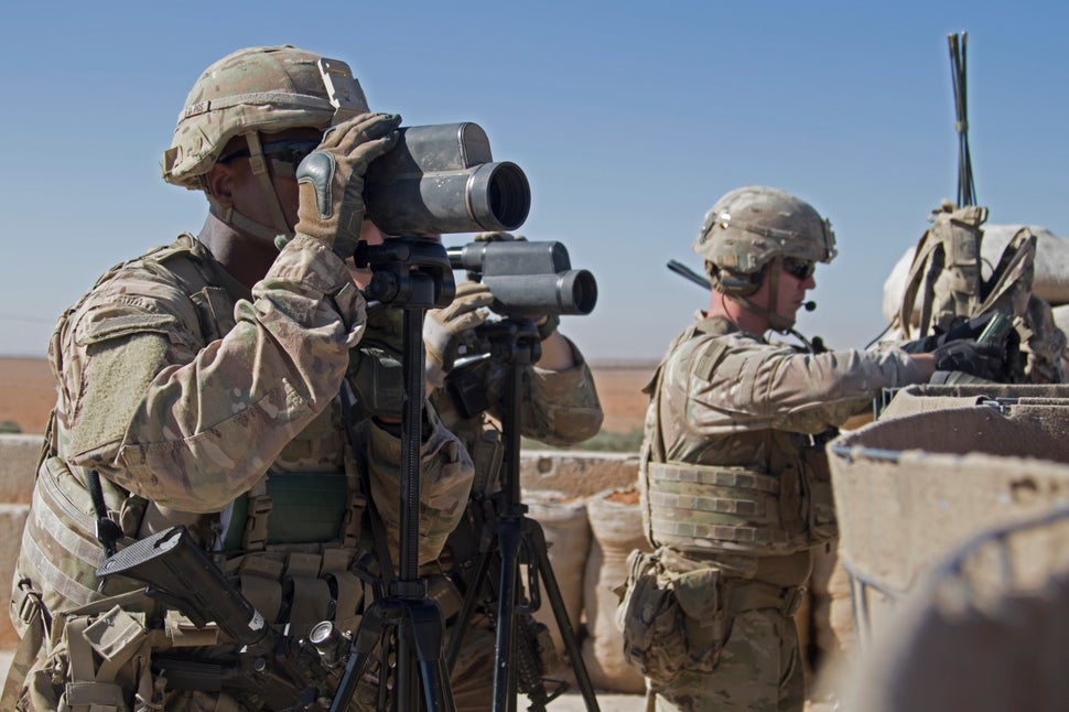 In this Nov. 1, 2018, photo released by the U.S. Army, soldiers surveil the area during a combined joint patrol in Manbij, Sy