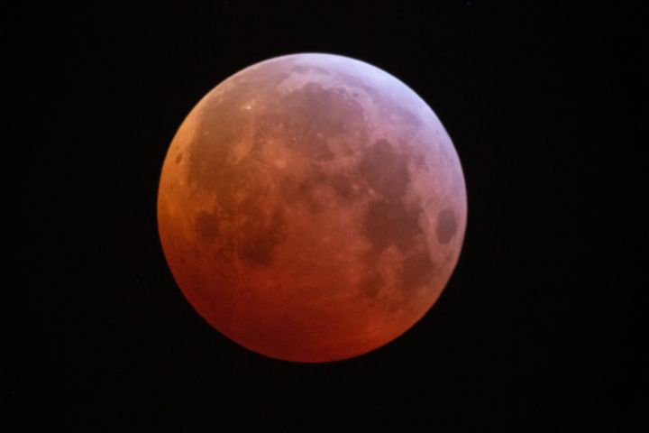 A lunar eclipse takes place, turning the moon red as it passes through the earths shadow in Newcastle upon Tyne, England.