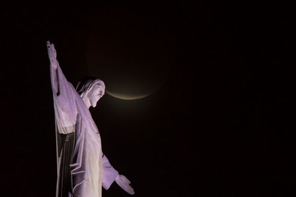 The blood moon rises above the Christ the Redeemer statue in Rio de Janeiro, Jan. 21.