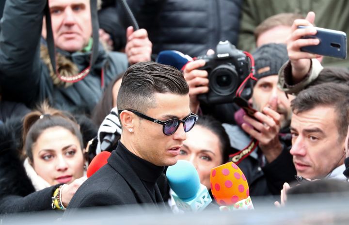 Cristiano Ronaldo leaves court in Madrid after accepting a deal in an ongoing tax fraud case.