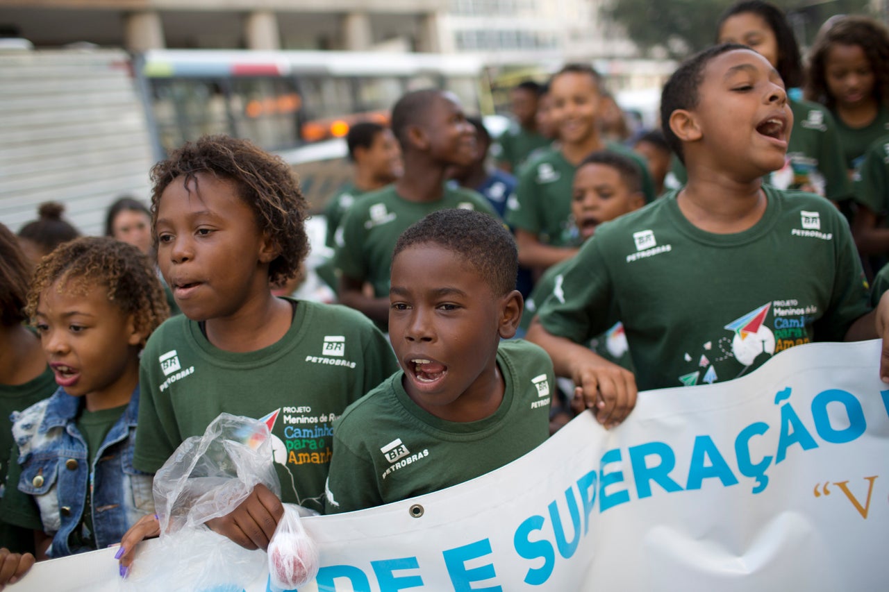 Children in Rio protest violence against black people during a march marking the 25th anniversary of the July 1993 Candelária massacre, when police killed at least eight people, including six minors, outside a cathedral.