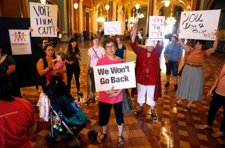 Protesters rally outside Iowa Gov. Kim Reynolds' office, on May 4, 2018, at the Statehouse in Des Moines.