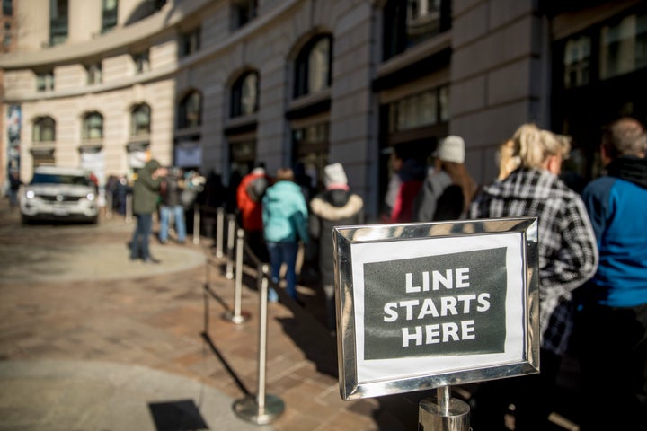 Furloughed workers wait in line on Tuesday to receive food and supplies from World Central Kitchen, the not-for-profit organization started by Chef Jose Andres in Washington, D.C.