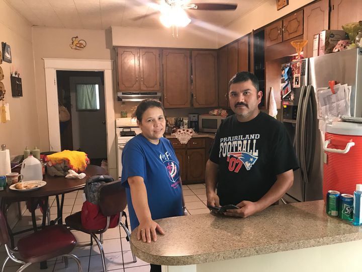 Oralia Rubio, left, and her husband, Hermenegildo, stand in the kitchen of their home in Honey Grove, Texas. Hermenegildo was one of 159 workers arrested by ICE at the Load Trail trailer plant in nearby Sumner on August 28, 2018. He now faces possible deportation.