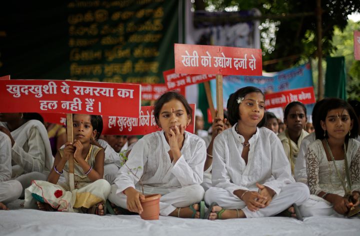 Children of farmers who committed suicide during a protest in New Delhi in July, 2017. Their campaign was for demanding better prices for farm produce and relief from debts. Placards on the left read, "Suicide is no solution to any problem" and those on the right, "Give farming industry status".
