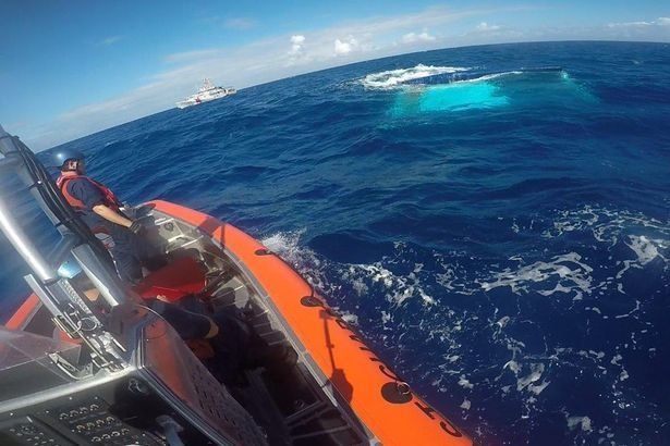 New photos show the moment US Coastguard rescuers approached the sunken catamaran off the coast of Cuba.