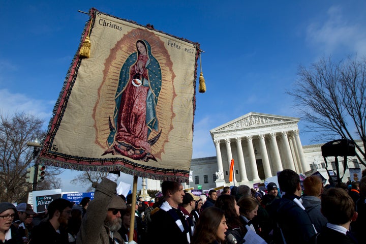 Anti-abortion demonstrators pass the Supreme Court during the March for Life, Jan. 18. The Covington students were in the capital to participate in the march.