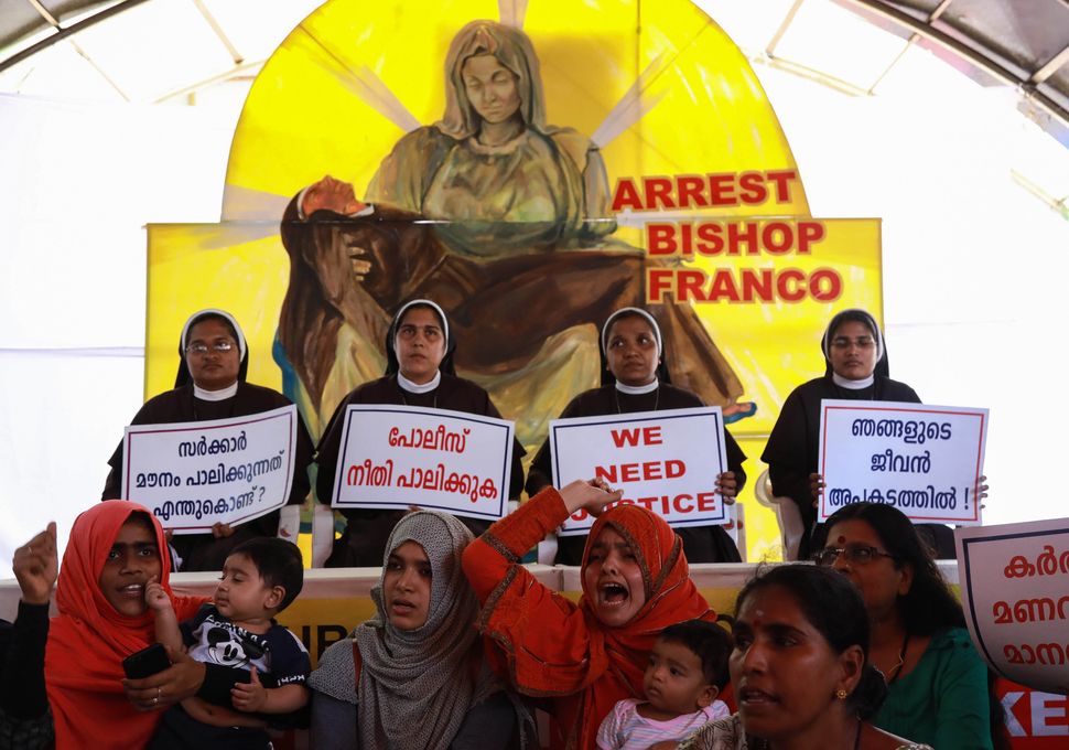 Indian Christian nuns and Muslim supporters protest as they demand the arrest of Bishop Franco Mulakkal, who is accused of raping a nun, outside the High Court in Kochi in the southern Indian state of Kerala on September 13, 2018 - Indian police on September 12 summoned for questioning a bishop accused by a nun of raping her multiple times, following days of protests by other nuns and supporters. Bishop Franco Mullackal, who has rejected the accusations, has been called for questioning in the southern state of Kerala on September 19, the Press Trust of India reported. (Photo by - / AFP) (Photo credit should read -/AFP/Getty Images)
