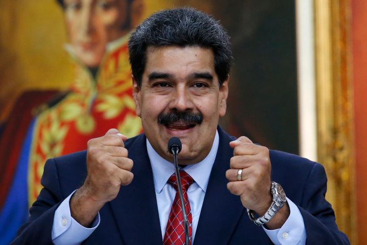 Venezuelan President Nicolas Maduro holds up his fists during a press conference at Miraflores presidential palace in Caracas on Friday.