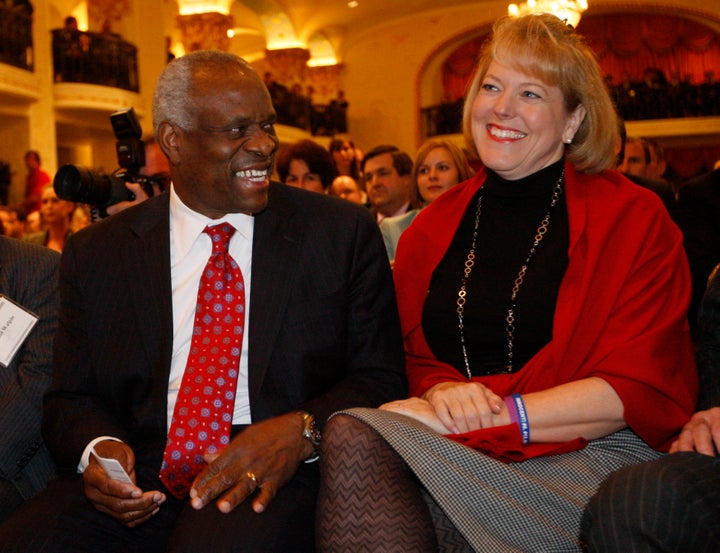 Supreme Court Justice Clarence Thomas sits with his wife Virginia Thomas in November 2007 as he is introduced at the Federalist Society in Washington. 