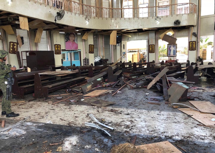 A soldier views the site inside a Roman Catholic cathedral in Jolo, the capital of Sulu province in the southern Philippines after two bombs exploded Sunday.