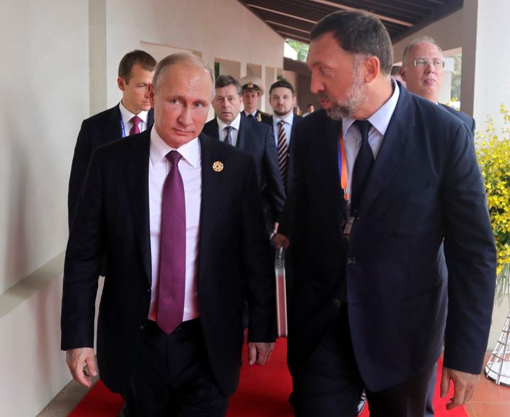 Russia's President Vladimir Putin, left, and Russian metals magnate Oleg Deripaska, right, walk to attend the APEC Business Advisory Council dialogue in Danang, Vietnam, Friday, Nov. 10, 2017.