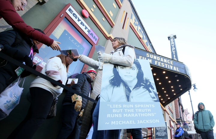 A protester hands out pamphlets to attendees at the documentary's premiere Friday at the Sundance Film Festival.