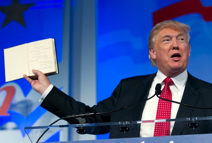 Trump holds up a Bible that was given to him by his mother as he speaks at the Values Voter Summit on Sept. 25, 2015.