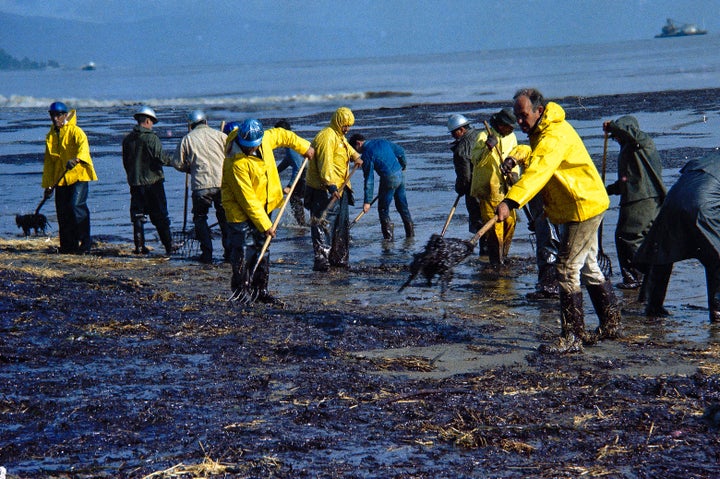 In this Feb. 6, 1969, file photo, state forestry conservation crews gather up oil-soaked straw on a beach in Santa Barbara.