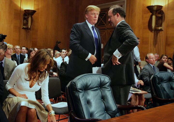 Donald Trump, then president of the Trump Organization, talks to Christopher Burnham, undersecretary general of the U.N. Department of Management, after Trump testified before a Senate Homeland Security and Governmental Affairs subcommittee on July 21, 2005, as his wife, Melania, accompanied him.