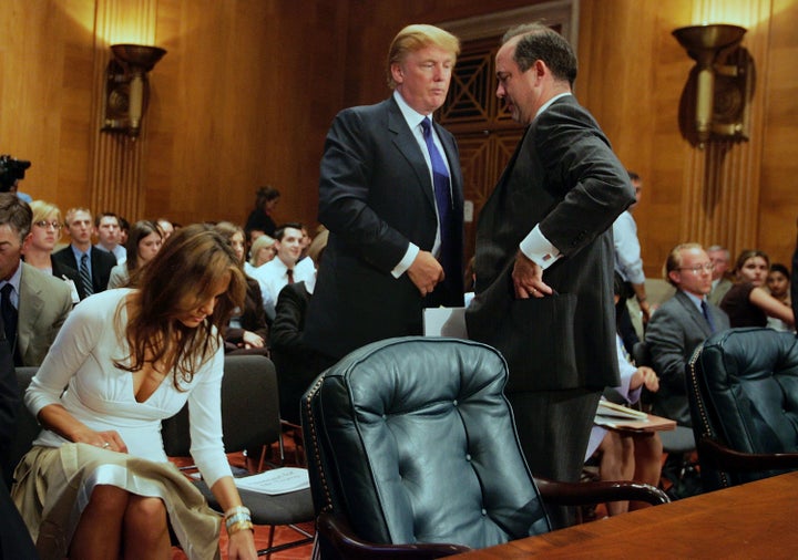 Donald Trump, then president of the Trump Organization, talks to Christopher Burnham, undersecretary general of the U.N. Department of Management, after Trump testified before a Senate Homeland Security and Governmental Affairs subcommittee on July 21, 2005, as his wife, Melania, accompanied him.