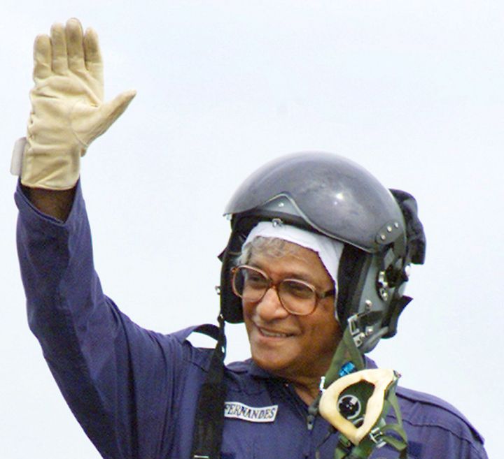 George Fernandes waves from the cockpit of a Russian-made MiG-21 fighter jet after riding it at Ambala air force base in the northern Indian state of Haryana August 1, 2003. 