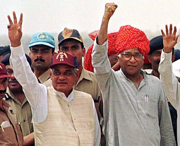Then Prime Minister Atal Behari Vajpayee and Defence Minister George Fernandes wave at soldiers at the Buddha Site, in the western desert state of Rajasthan, where India carried out nuclear tests last week. Vajpayee, after a visit to the site in the far-flung Pokhran range, said India was forced to conduct the series of five nuclear tests to silence its enemies and show its strength. SM/JDP