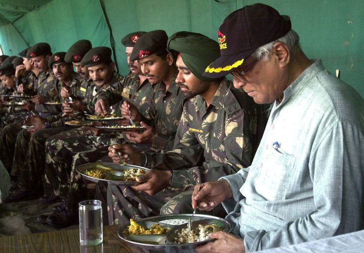 George Fernandes has a lunch with soldiers of the Indian Army at an army base in Shariefabad, north of Srinagar India, on 3 August, 2002. 