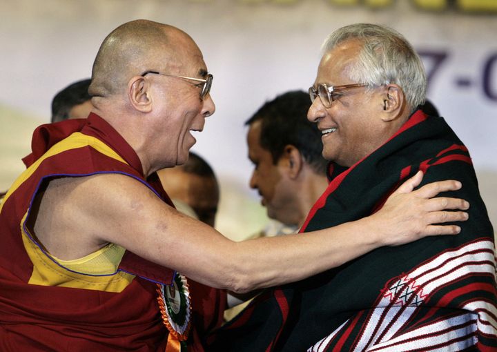 ibetan spiritual leader the Dalai Lama gestures as he felicitate former Union Defence minister George Fernandes during a function in Bangalore, 17 January, 2008. 