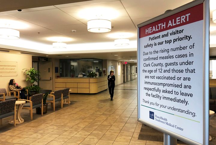 In this Jan. 25, 2019 photo, a sign at the entrance to PeaceHealth Southwest Medical Center in Vancouver, Washington prohibits all children under 12 and unvaccinated adults due to the number of measles cases in Clark County.