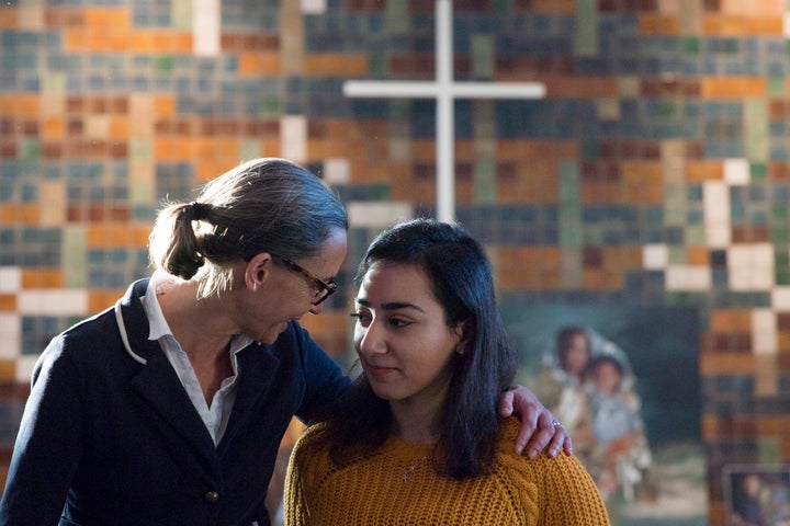 Hayarpi Tamrazyan, a 21-year-old Armenian asylum-seeker (right) gets a hug from spokesperson Florine Kuethe inside the Bethel chapel in The Hague, Netherlands, in December.