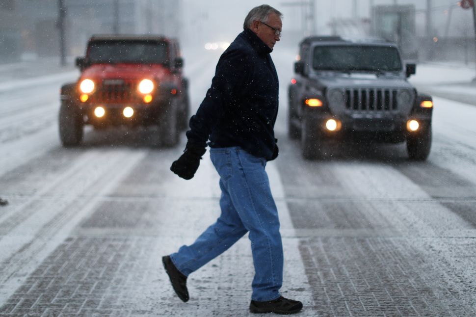 Commuters brave the wind and snow in frigid weather, Wednesday, Jan. 30, 2019, in Cincinnati.