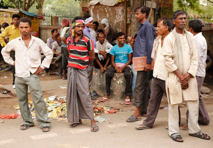 Daily wage laborers wait to get employed for the day.