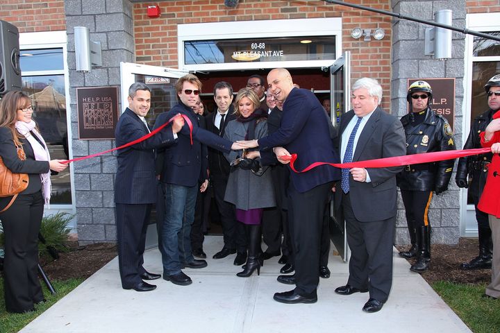 From left, North Ward councilman Anibal Ramos Jr., musician Jon Bon Jovi, designer Kenneth Cole, HELP USA Chairman Maria Cuomo Cole, Newark Mayor Cory Booker and HELP USA President Laurence Belinsky cut the ribbon at the opening of a Newark housing project funded through Bon Jovi’s JBJ Soul Foundation, Dec. 8, 2009. 
