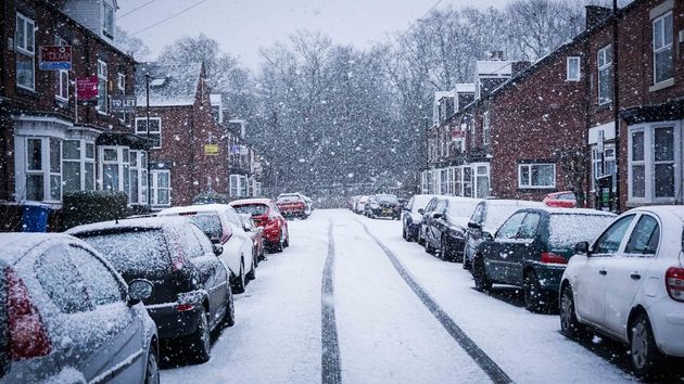 Vehicles seen parked during snowfall in Sheffield city centre on Saturday.