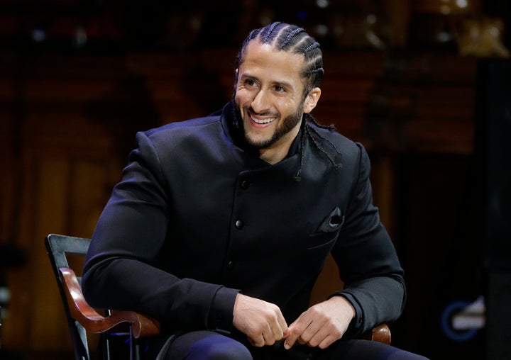 Former NFL football quarterback Colin Kaepernick is seated on stage during W.E.B. Du Bois Medal ceremonie at Harvard University in October. 