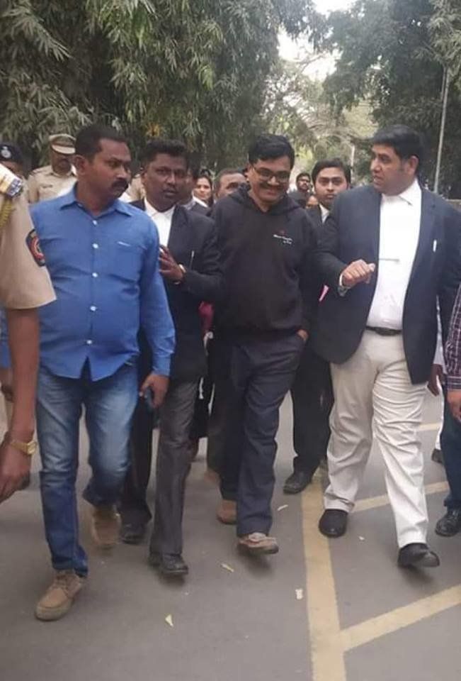 Anand Teltumbde walking out of Pune district court with his lawyer Rohan Nahar on Saturday after being released