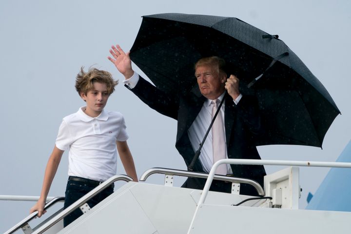 President Donald Trump and his son Barron board Air Force One at Palm Beach International Airport in West Palm Beach, Fla., Monday, Jan. 15, 2018, to travel to Washington.