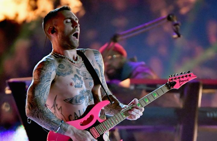 Maroon 5 singer Adam Levine removed his shirt while performing in the Super Bowl halftime show on Sunday. 