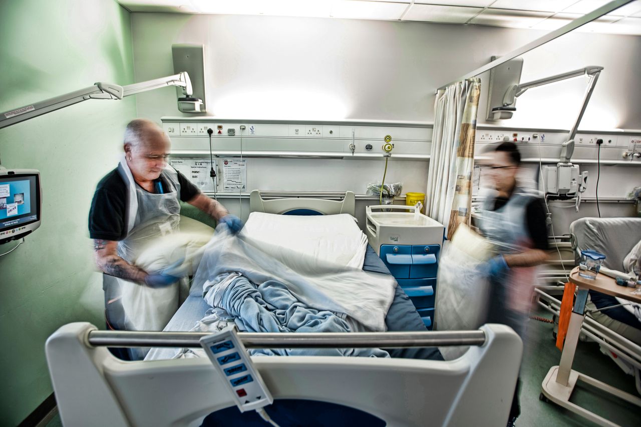 Robert Sharp and Mohammed Patel, the bed-making team, clean beds thoroughly between patients