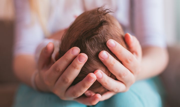 Stock photo of mom holding newborn baby. 