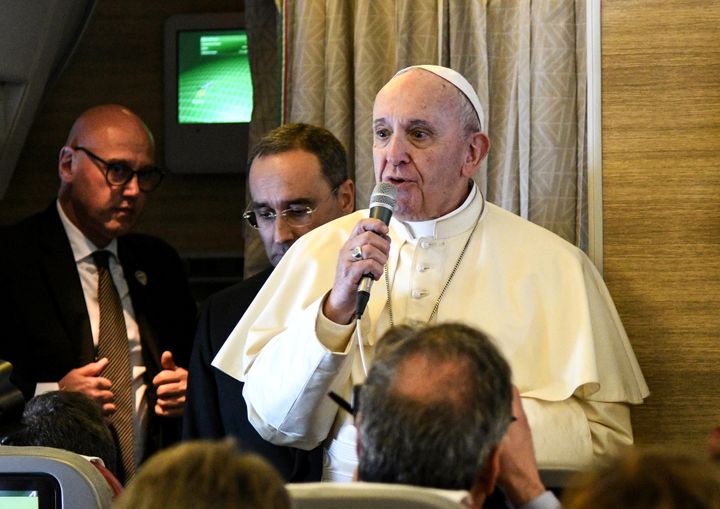 Pope Francis speaks to reporters aboard a plane on his way to Abu Dhabi on February 3, 2019. 