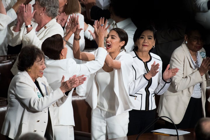 Rep. Alexandria Ocasio-Cortez (D-N.Y.) sharing a moment with her colleagues at a different point in the night.