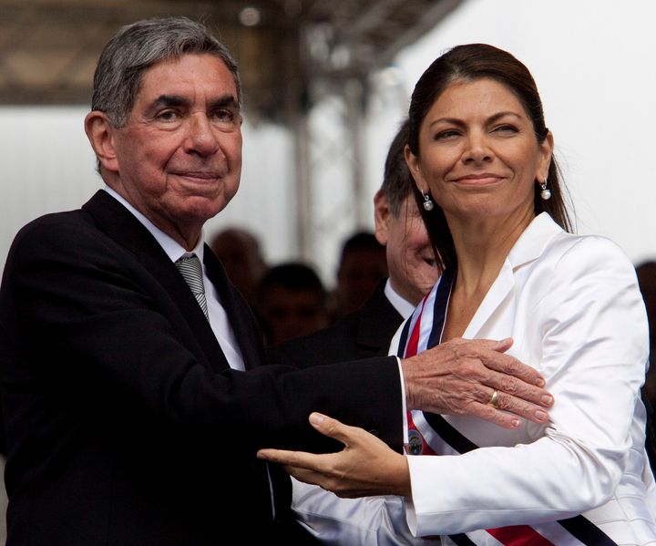 Costa Rica's then-President Laura Chinchilla, right, seen embracing outgoing president Oscar Arias on May 8, 2010. 
