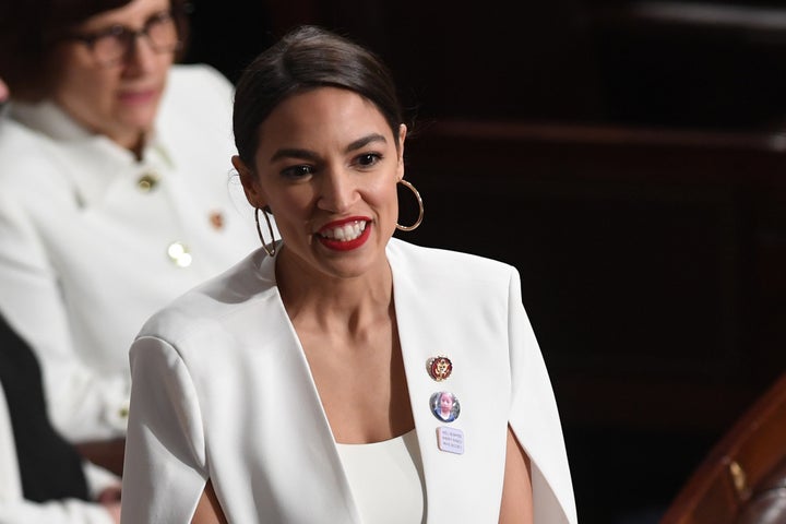 Ocasio-Cortez wears white and dons a pin commemorating Guatemalan migrant Jakelin Caal Maquin at Tuesday night's State of the Union address. 