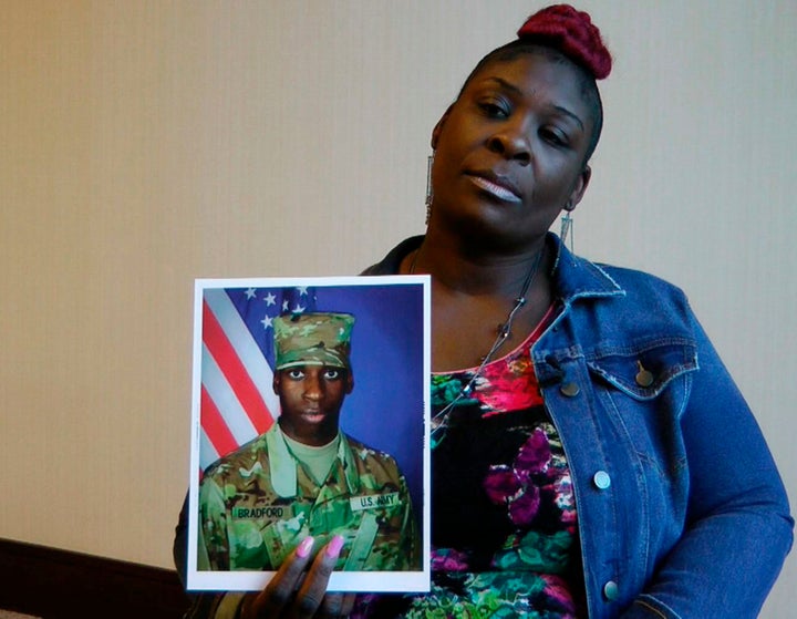 April Pipkins holds a photograph of her deceased son, Emantic "EJ" Bradford Jr., who was fatally shot by police after being m