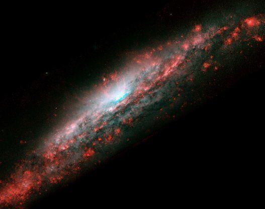 Galaxy NGC 3079, located 50 million light-years from Earth in the constellation Ursa Major, has a huge bubble of gas in the center of its disc. Hubble Space Telescope (HST).
